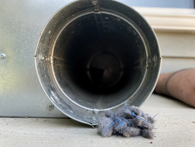 Rossmoor Dryer Vent Cleaning technician using specialized equipment to clear severe dryer vent blockage in Rossmoor